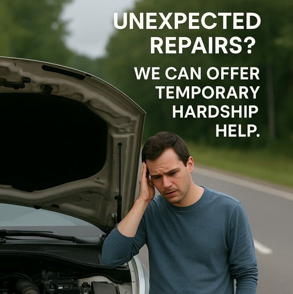 Man with car hood up on the side of the road, struggling to get his car working.