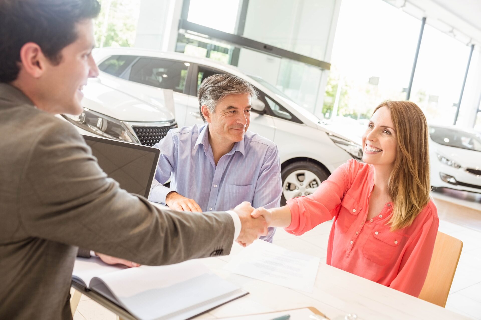 Smiling couple buying a new car