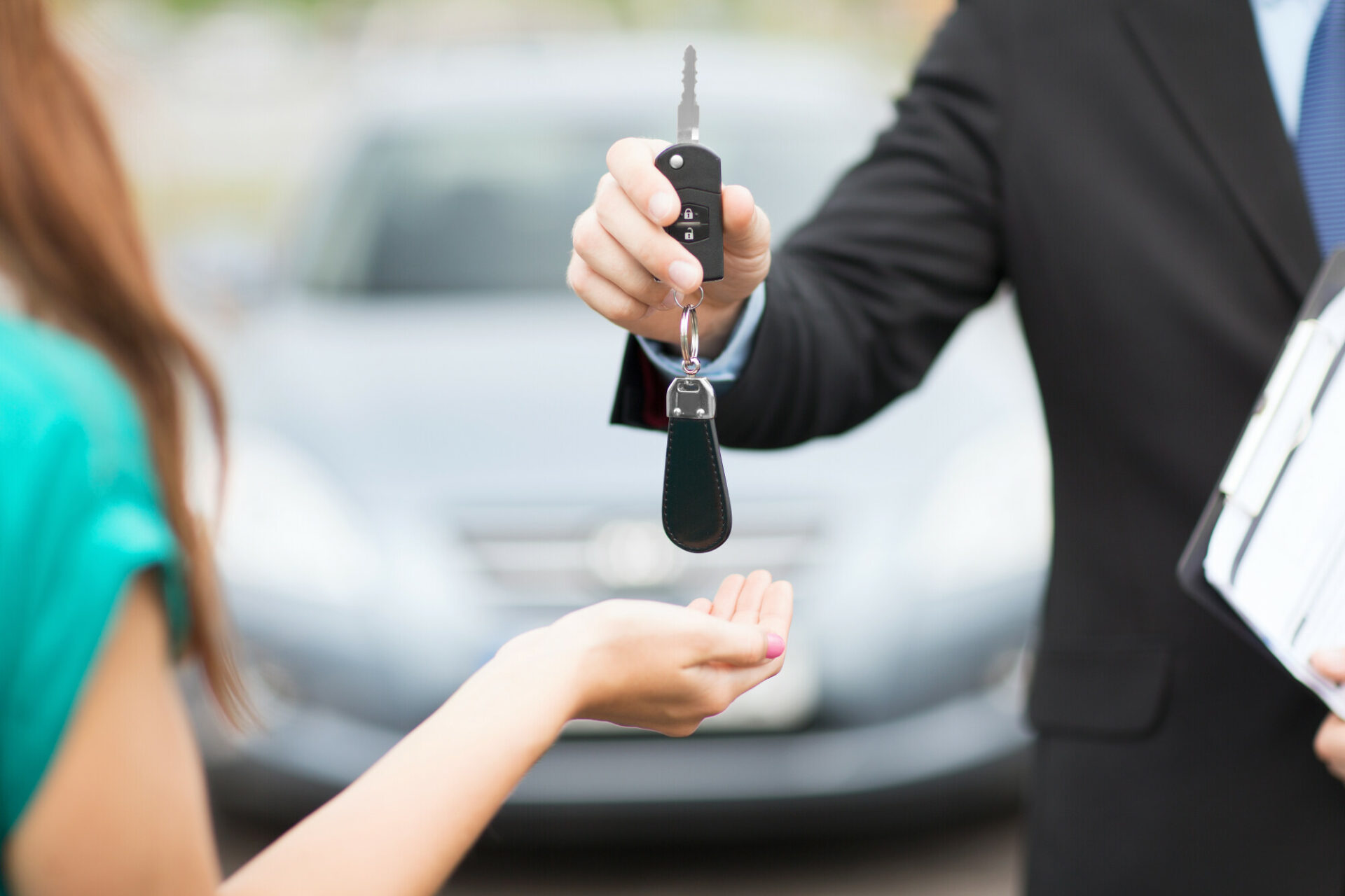 Salesman Handing Keys To Car